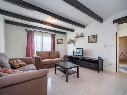 a living room with two couches and a tv at Holiday Home Dorijano by Interhome in Ripenda Kras
