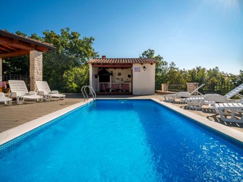 a swimming pool with chairs and a gazebo at Holiday Home Dorijano by Interhome in Ripenda Kras