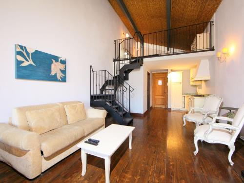 un soggiorno con divano e una scala a chiocciola di Apartment Tipologia Bilocale by Interhome a Le Vedute