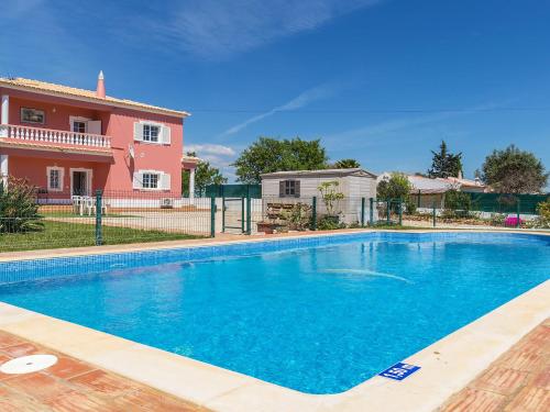 a swimming pool in front of a house at Villa Das Amendoeiras by Interhome in Estevais