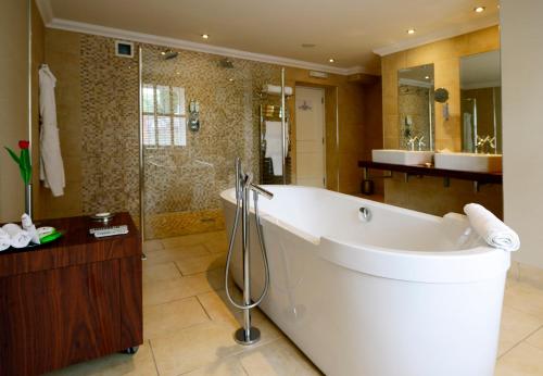 a large bathroom with a tub and a shower at Rocpool Reserve Hotel in Inverness