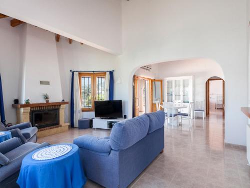 a living room with a blue couch and a tv at Villa Jillian by Interhome in Monte Pego