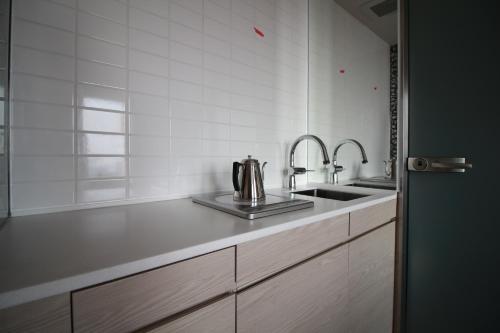 uma cozinha com um lavatório e uma bancada em Meitetsu Inn Kariya em Kariya