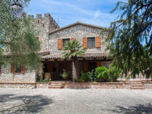 ein Steinhaus mit einer Palme davor in der Unterkunft Villa Olivo secolare by Interhome in Castelrinaldi