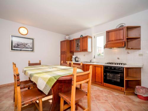 a kitchen with a table and a table and chairs at Apartment Hilde Blue-3 by Interhome in Medulin