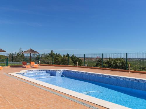 a swimming pool on a patio with a view of the ocean at Villa Casa da Horta by Interhome in Estevais