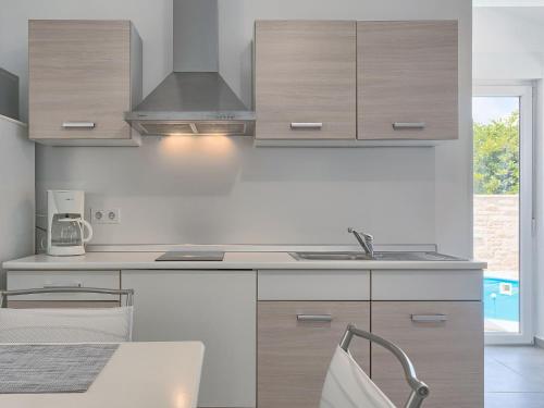 a kitchen with wooden cabinets and a sink at Holiday Home Lino by Interhome in Štinjan