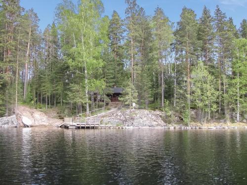 a cabin on the shore of a lake at Holiday Home Päivärinne by Interhome in Vuoriniemi