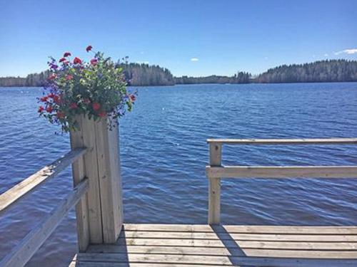 a wooden dock with a potted plant on the water at Holiday Home Suviranta by Interhome in Syvärinpää