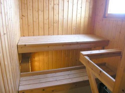 a wooden sauna with two wooden benches in it at Holiday Home Karpalo by Interhome in Jokijärvi