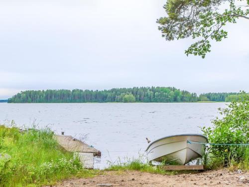un barco sentado en la orilla de un lago en Holiday Home Petäjäniemi by Interhome, en Leskelä