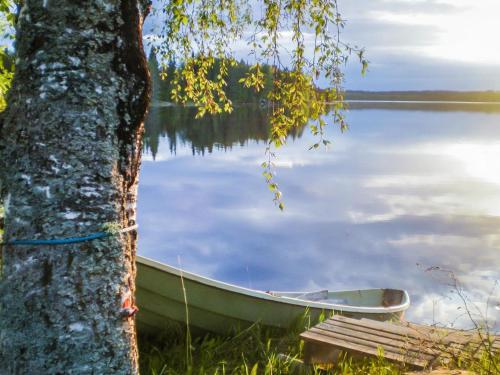 a boat sitting on the shore of a lake at Holiday Home Ettone by Interhome in Lipinlahti