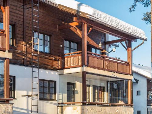 a house with a deck on top of it at Holiday Home Point vale 4 ap-3 by Interhome in Tahkovuori