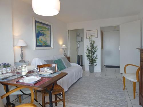 a living room with a bed and a table at Apartment l'Amiral by Interhome in Trouville-sur-Mer