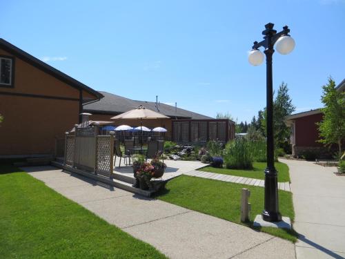 a street light and an umbrella on a sidewalk at Village Creek Country Inn in Westerose