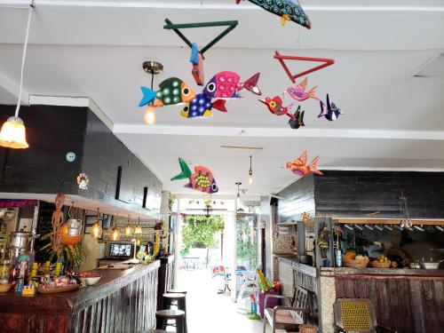 a restaurant with colorful kites hanging from the ceiling at Hotel La Piazzetta in Mérida