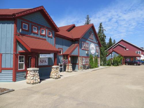 a blue building with red roofs in a street at Village Creek Country Inn in Westerose