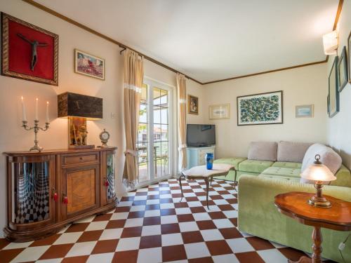 a living room with a couch and a checkered floor at Holiday Home Zora by Interhome in Njivice