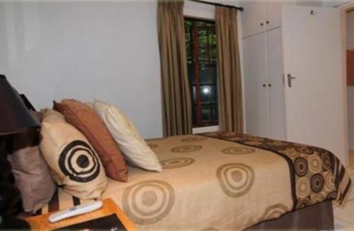 a bedroom with a large bed with pillows at Rivendell Bed and Breakfast in Hillcrest