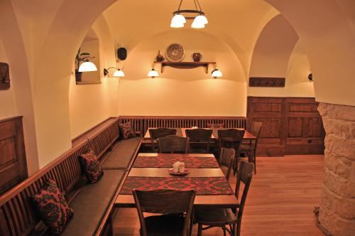 a restaurant with tables and chairs in a room at Penzion na Faře in Dubenec