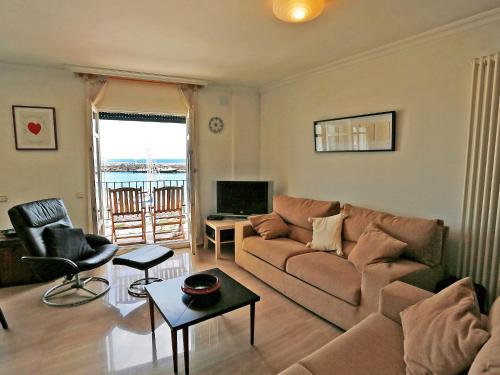 a living room with a couch and a tv at Apartment Cambrils Port by Interhome in Cambrils
