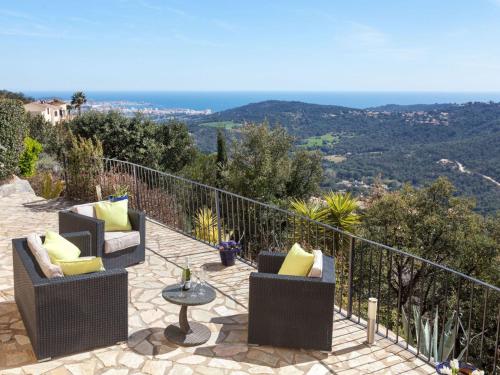 a patio with two chairs and a table with a view at Holiday Home Lausanne by Interhome in Calonge