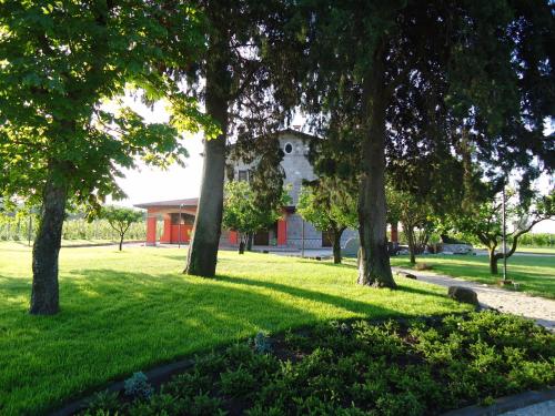 a group of trees in front of a building at Agrituirsmo Masseria Campierti in Falciano del Massico