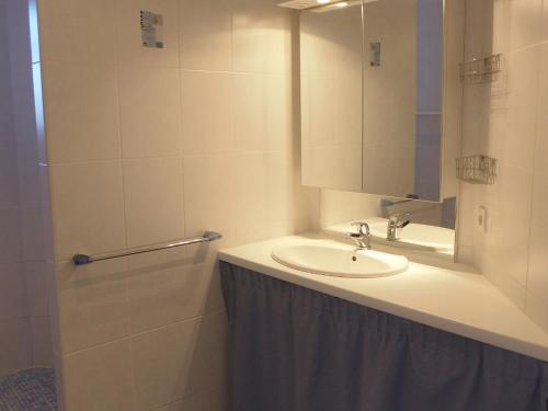 a bathroom with a sink and a mirror at Holiday Home Sainte Marie by Interhome in Tosse