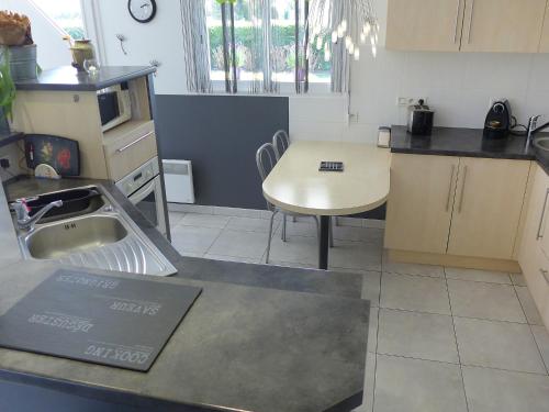a kitchen with a table and a sink and a table at Holiday Home Sainte Marie by Interhome in Tosse