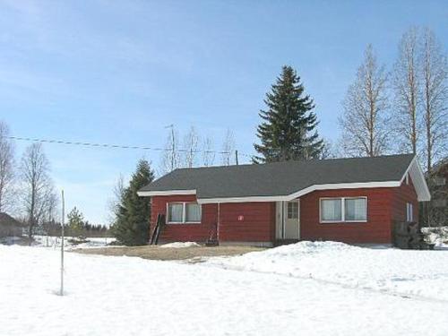 a red house with snow in front of it at Holiday Home Herkkola by Interhome in Jokijärvi