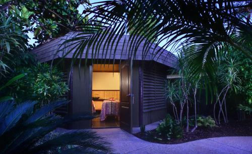 a house with a table in the middle of a garden at Paradise Point Resort & Spa in San Diego