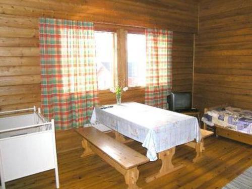 a room with a table and a television in a cabin at Holiday Home Riitula by Interhome in Jokijärvi