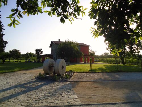 a park with two stone statues in front of a building at Agrituirsmo Masseria Campierti in Falciano del Massico
