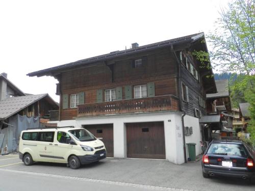 a white van parked in front of a building at Apartment Studio Oehrli by Interhome in Gstaad