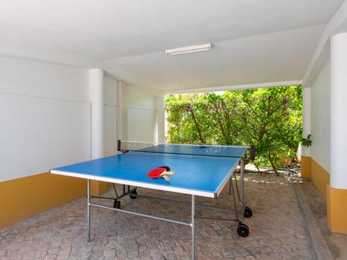 a ping pong table with a ping pong ball on it at Villa Villa Natura by Interhome in Guia