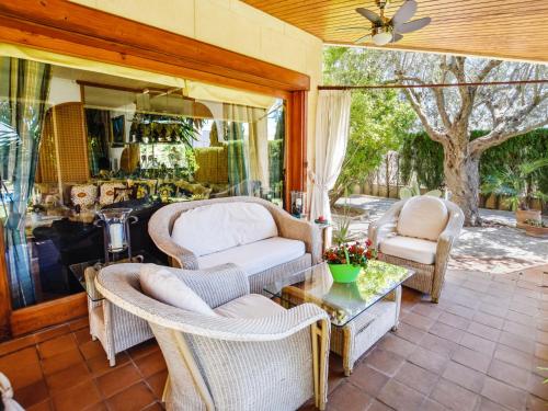 a patio with wicker chairs and a table at Villa Can Joan by Interhome in Lloseta