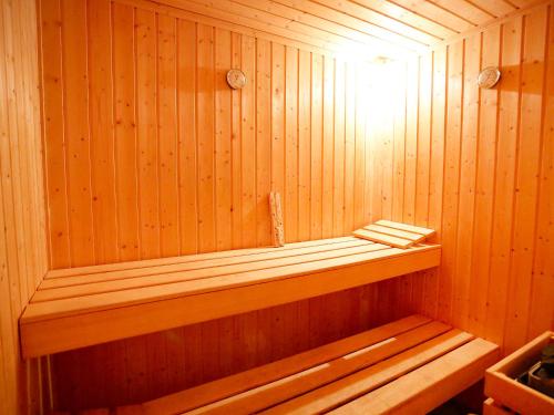 a wooden sauna with a wooden bench in it at Holiday Home L'Aldea by Interhome in L'Aldea