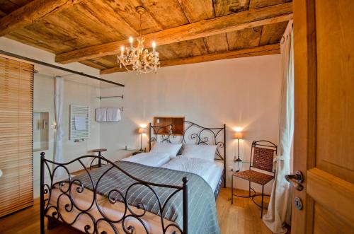 a bedroom with a bed and a chandelier at Case di Sotto, House & Breakfast in Locarno