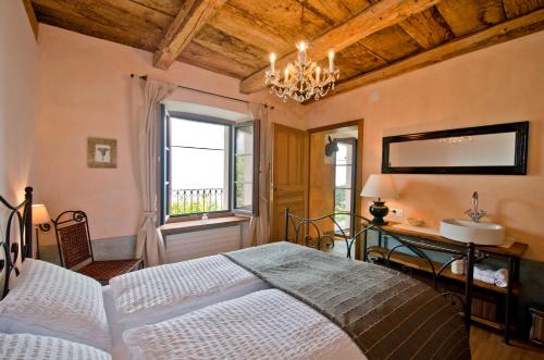 a bedroom with a large bed and a window at Case di Sotto, House & Breakfast in Locarno
