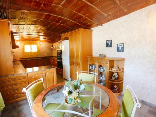 a kitchen with a table and chairs in a room at Holiday Home L'Aldea by Interhome in L'Aldea