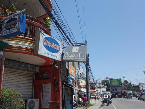 a street with signs on the side of a building at Center Parkway Pension House in Kalibo