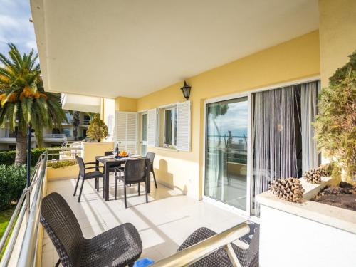 a patio with a table and chairs on a balcony at Apartment Vista al Mar by Interhome in Port d'Alcudia