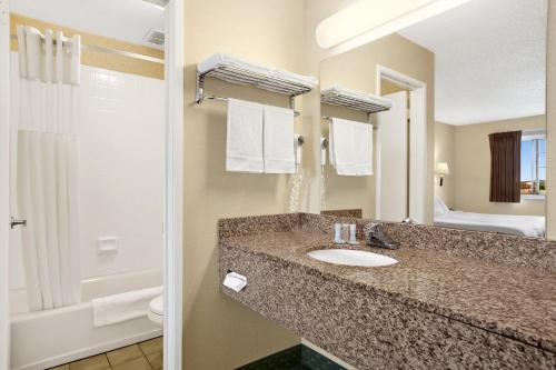 a bathroom with two sinks and a mirror at Travelodge by Wyndham San Francisco Bay in San Francisco
