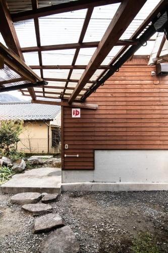 a garage door with a sign on it at Yufuin Yukari-an Megumi no Sato in Yufuin