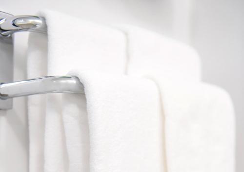 a shower curtain in a bathroom with a towel at Hotel Trend Mikawaanjo in Anjomachi