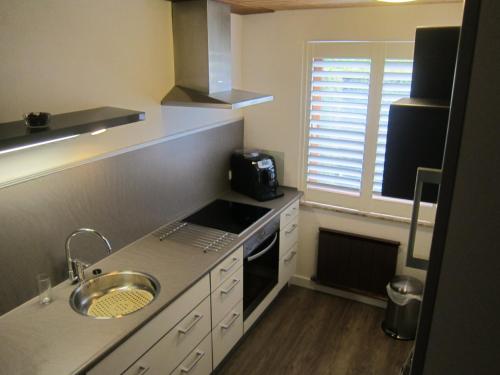 a small kitchen with a sink and a stove at Huis Fitaniki in Leogang