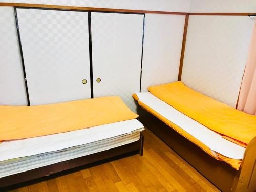 Ένα ή περισσότερα κρεβάτια σε δωμάτιο στο Minshuku Kaikeibo