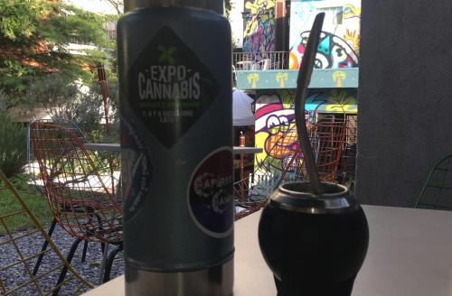 a drink sitting on a table next to a cup at Destino26 Hostel in Montevideo