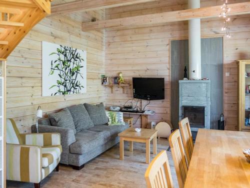 a living room with a couch and a table at Holiday Home Villa koira nr2 by Interhome in Vuokatti