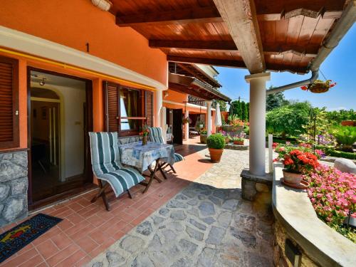 a patio with chairs and a table on a house at Apartment Lidija by Interhome in Matulji